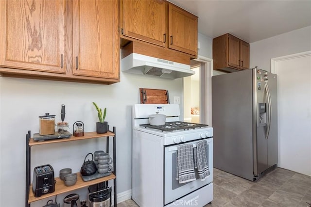 kitchen with white gas stove and stainless steel fridge