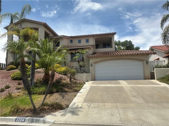 mediterranean / spanish-style home with a garage