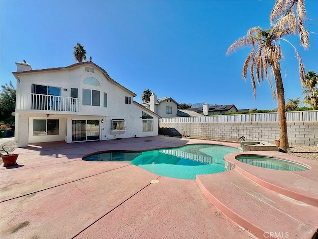 view of pool with an in ground hot tub and a patio