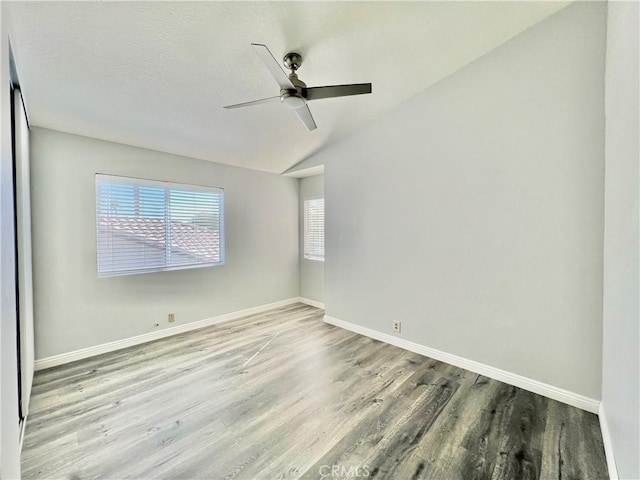 unfurnished room featuring vaulted ceiling, ceiling fan, and hardwood / wood-style floors