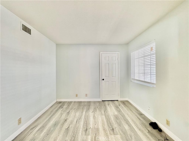 spare room featuring light hardwood / wood-style flooring