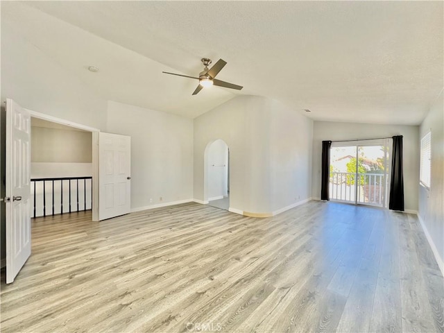 empty room with vaulted ceiling, ceiling fan, and light wood-type flooring