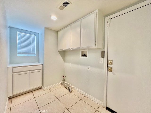 washroom with cabinets, hookup for a gas dryer, washer hookup, and light tile patterned floors