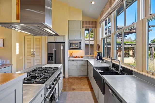 kitchen featuring island exhaust hood, vaulted ceiling, high end appliances, and white cabinets