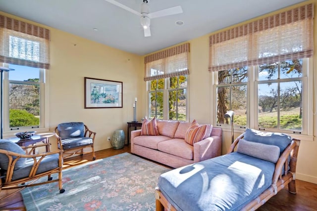 living room with wood-type flooring, plenty of natural light, and ceiling fan