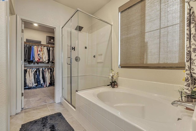 bathroom featuring tile patterned flooring and independent shower and bath