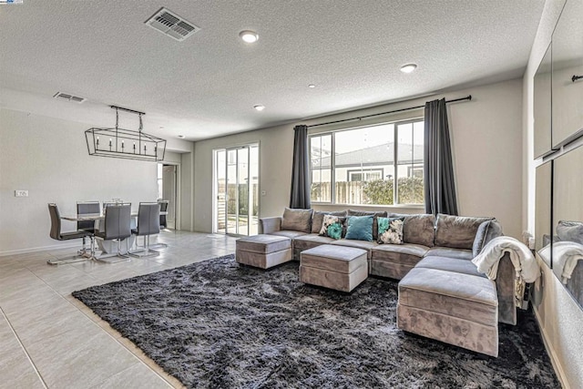 living room with tile patterned flooring and a textured ceiling