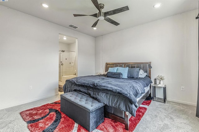 carpeted bedroom featuring ceiling fan and ensuite bath