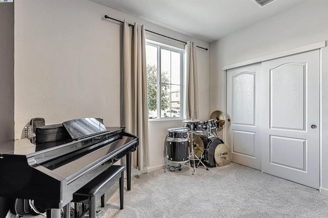 miscellaneous room featuring light carpet