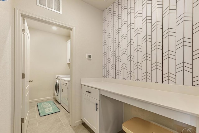 clothes washing area with light tile patterned floors and washing machine and clothes dryer