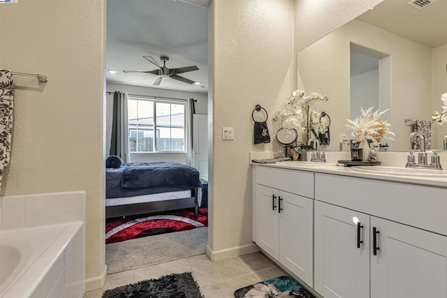 bathroom with vanity, a tub, tile patterned floors, and ceiling fan