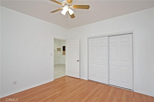 unfurnished bedroom with hardwood / wood-style flooring, ceiling fan, and a closet