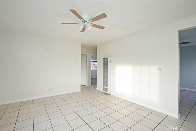 unfurnished room featuring ceiling fan and light tile patterned flooring