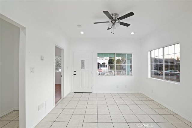 unfurnished room with light tile patterned flooring and ceiling fan