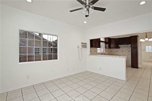 spare room with light tile patterned flooring, plenty of natural light, and ceiling fan