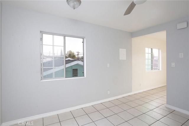 tiled empty room with ceiling fan