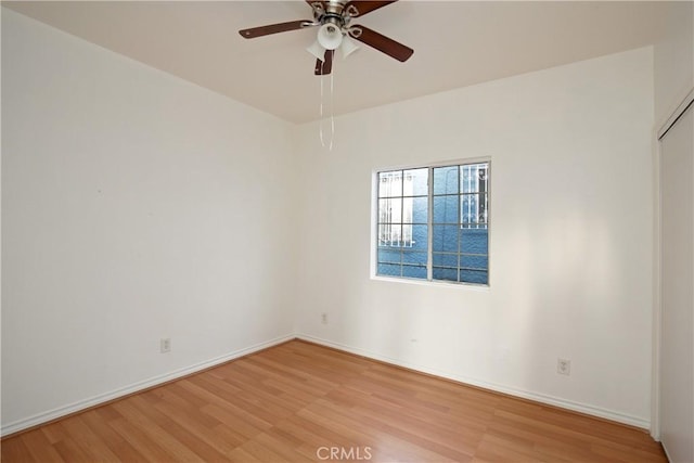 unfurnished room with ceiling fan and light wood-type flooring