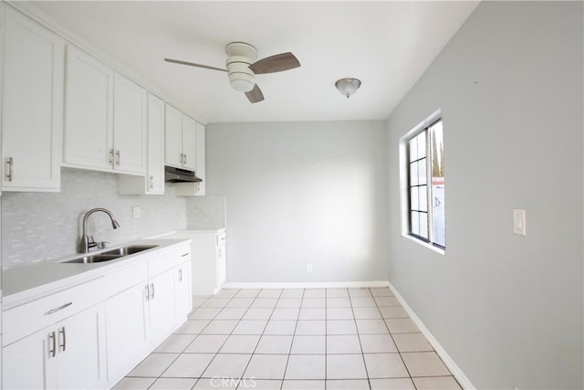 kitchen featuring sink, ceiling fan, backsplash, white cabinets, and light tile patterned flooring