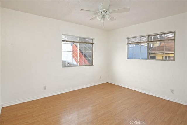 unfurnished room featuring hardwood / wood-style floors, a textured ceiling, and ceiling fan