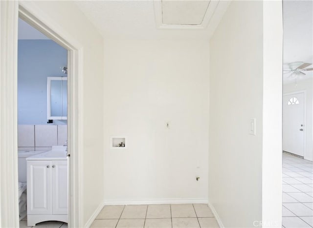 washroom with hookup for a washing machine and light tile patterned floors