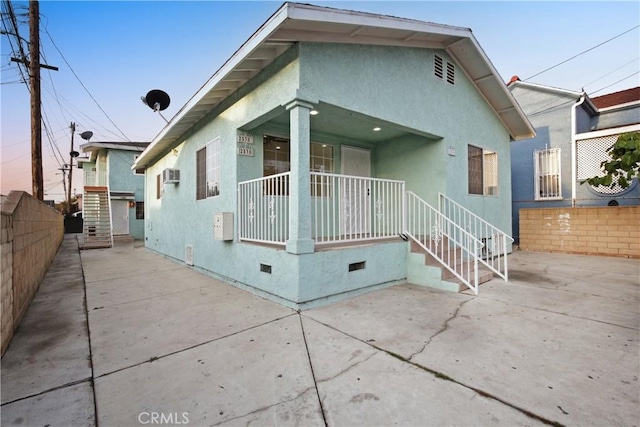 view of front of house with covered porch and a patio