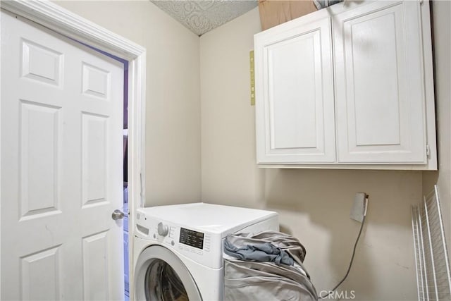 laundry room featuring washer / clothes dryer and cabinets