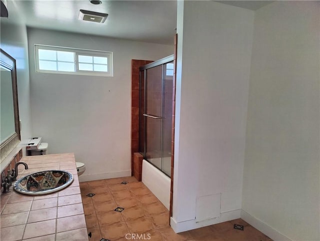 full bathroom with vanity, shower / bath combination with glass door, and toilet