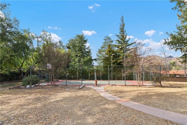 surrounding community featuring a mountain view and tennis court