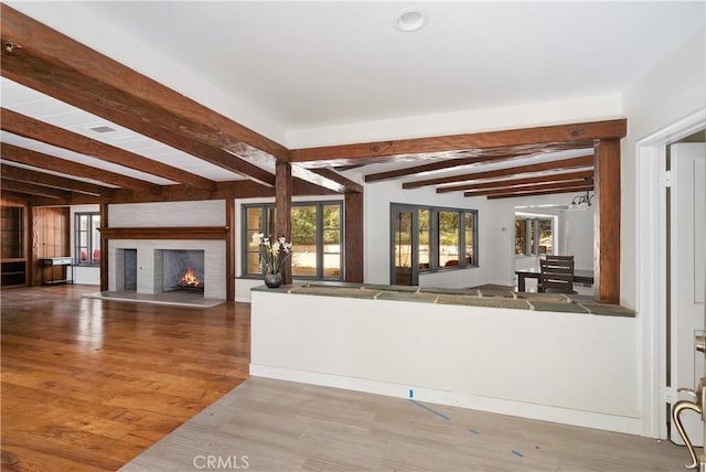 kitchen featuring hardwood / wood-style flooring and beamed ceiling