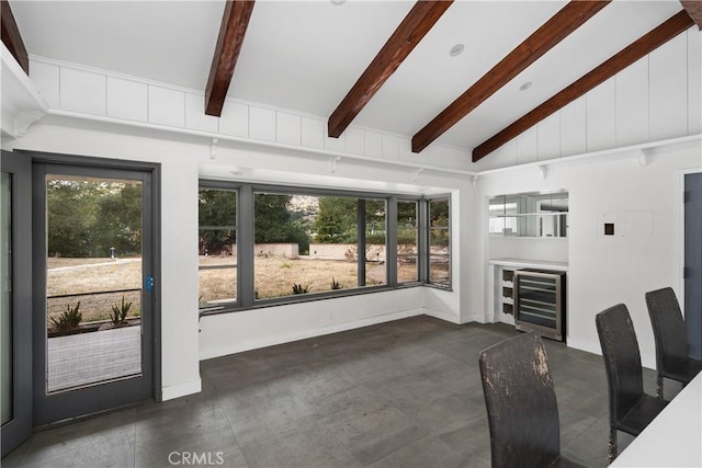 interior space featuring lofted ceiling with beams and beverage cooler