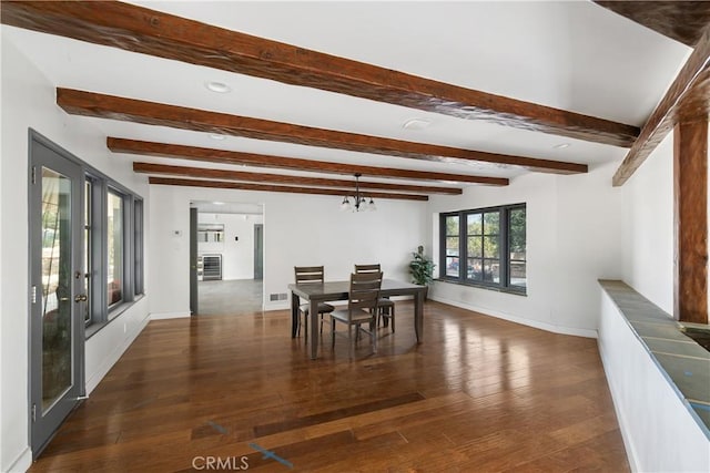 dining area with a notable chandelier, dark wood-type flooring, french doors, and beamed ceiling