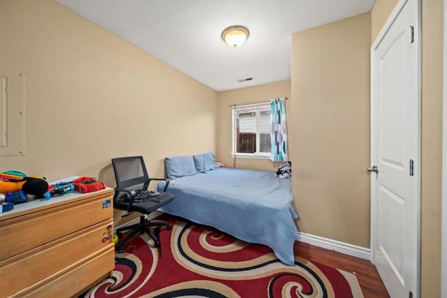 bedroom featuring dark hardwood / wood-style flooring