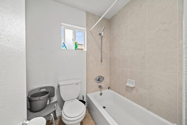 bathroom featuring tiled shower / bath combo, tile patterned floors, and toilet