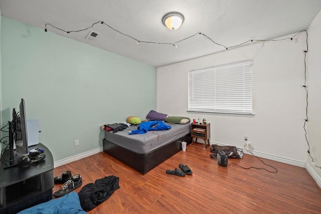 bedroom featuring hardwood / wood-style floors