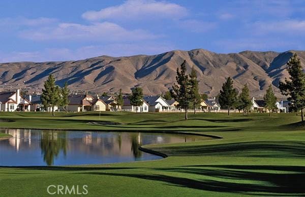 view of home's community featuring a yard and a water and mountain view