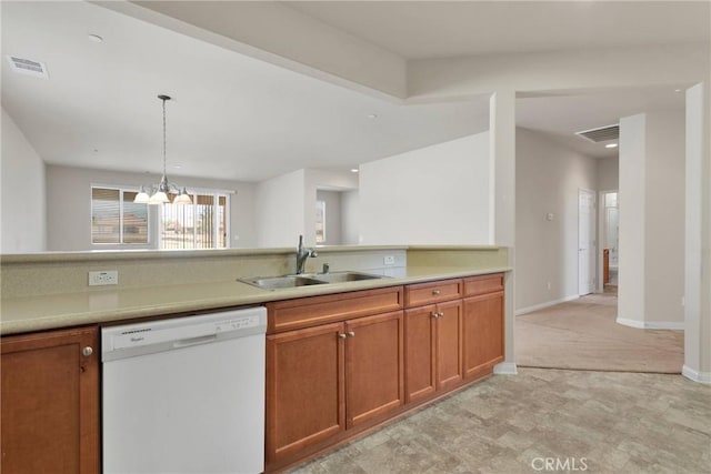 kitchen featuring an inviting chandelier, white dishwasher, decorative light fixtures, and sink