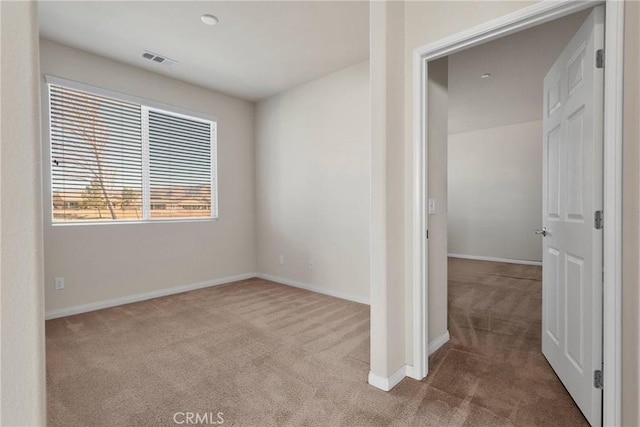 spare room featuring light carpet