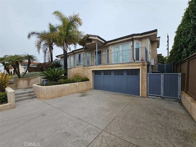 view of front of home with a garage and a balcony