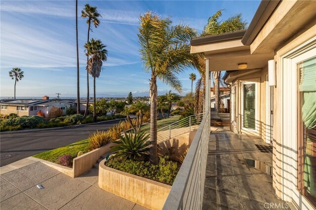 view of patio featuring a balcony