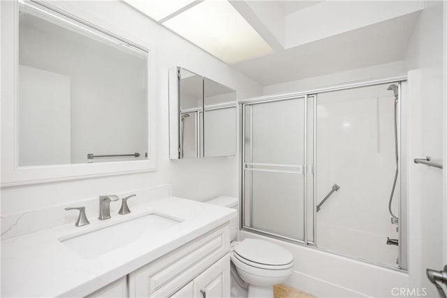 full bathroom with vanity, toilet, and combined bath / shower with glass door