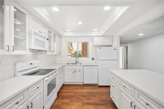 kitchen featuring sink, white cabinetry, ornamental molding, a raised ceiling, and white appliances