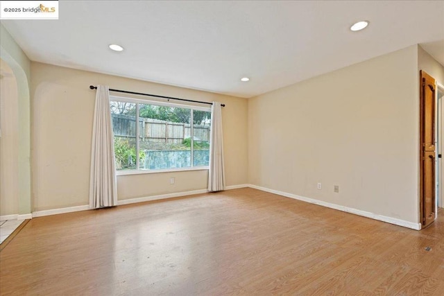 spare room with light hardwood / wood-style flooring