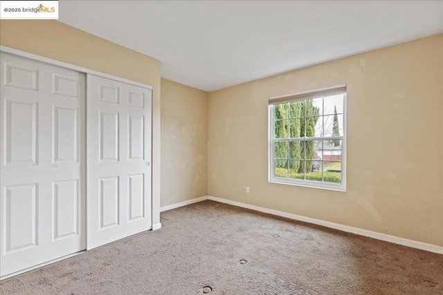 unfurnished bedroom with a closet and carpet