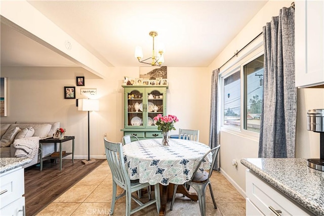 dining area with an inviting chandelier