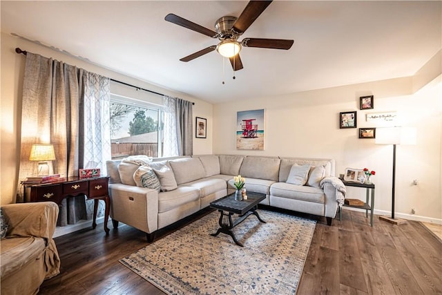 living room featuring ceiling fan and dark hardwood / wood-style flooring