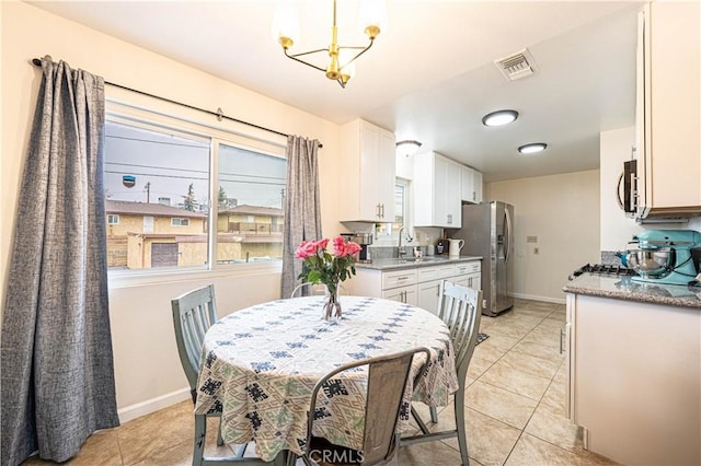 dining room featuring light tile patterned flooring and sink