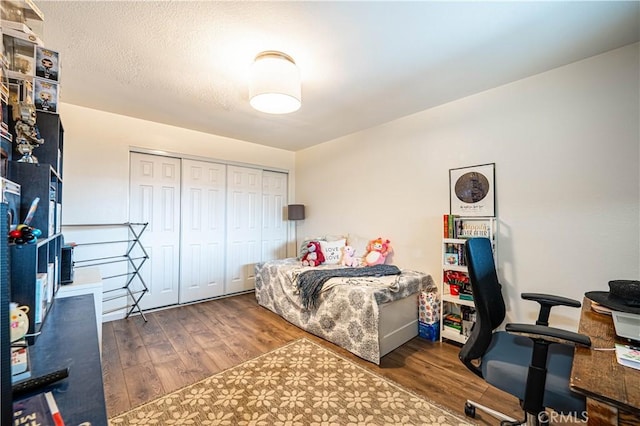 bedroom featuring a closet and dark hardwood / wood-style floors