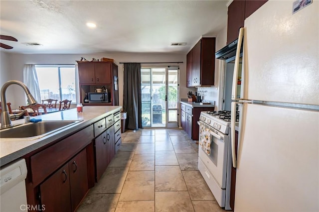 kitchen with ceiling fan, sink, light tile patterned floors, and white appliances