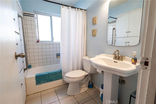 bathroom with shower / bath combination with curtain, tile patterned floors, and toilet