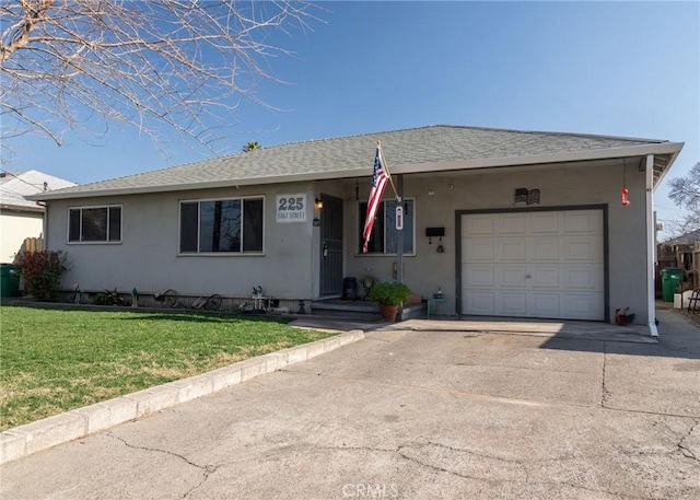 ranch-style house featuring a garage and a front lawn